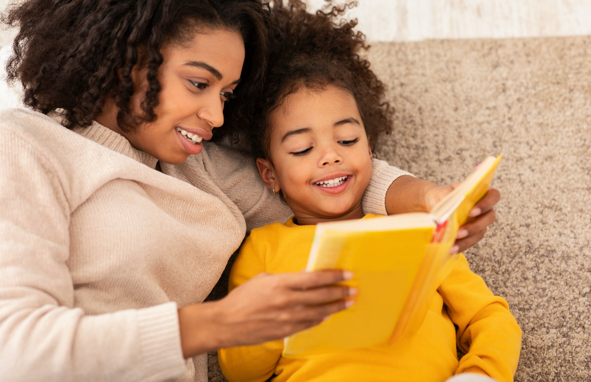 Woman reads to her female child