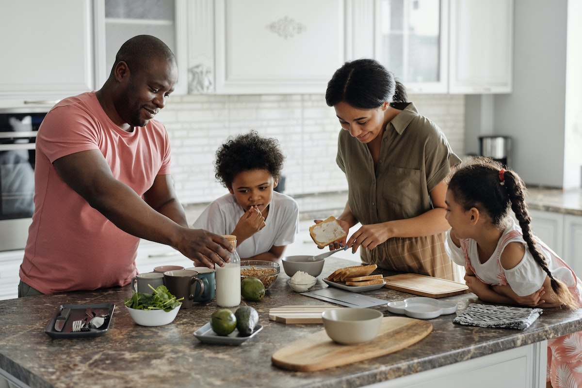 Family prepares healthy meal together in the kitchen
